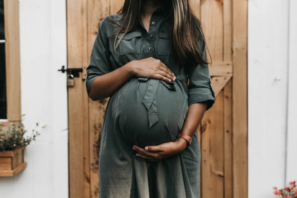 Women hold her pregnant stomach.