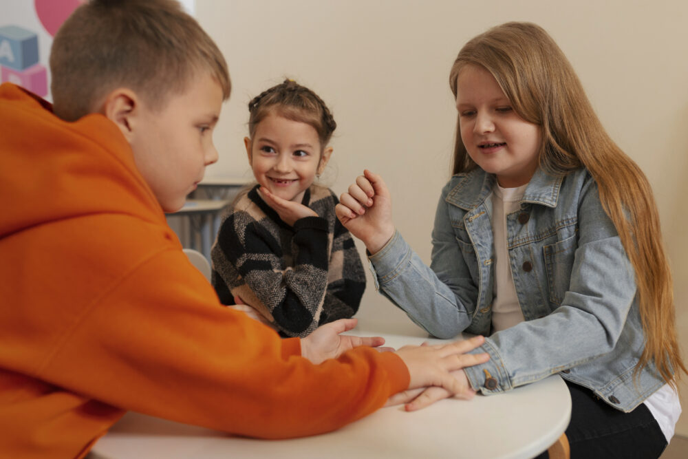 Children sitting together at a table during a group activity.